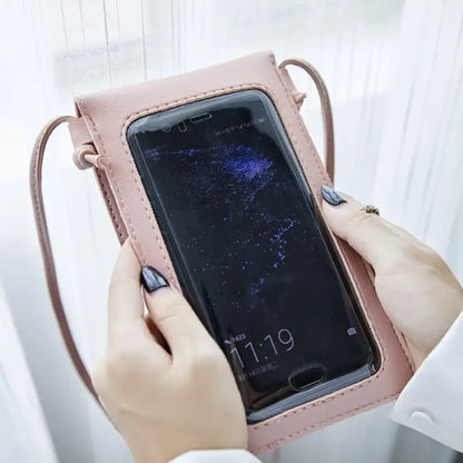 Hands holding a pink phone pouch with a transparent back pocket for easy smartphone access.