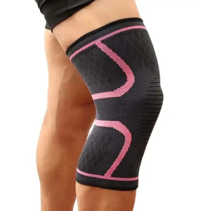 Close-up of black knee support sleeve with pink geometric accents, worn on leg against light background