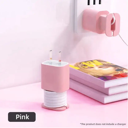 Compact pink charger organizer with coiled cord design for stylish and tangle-free cable storage.