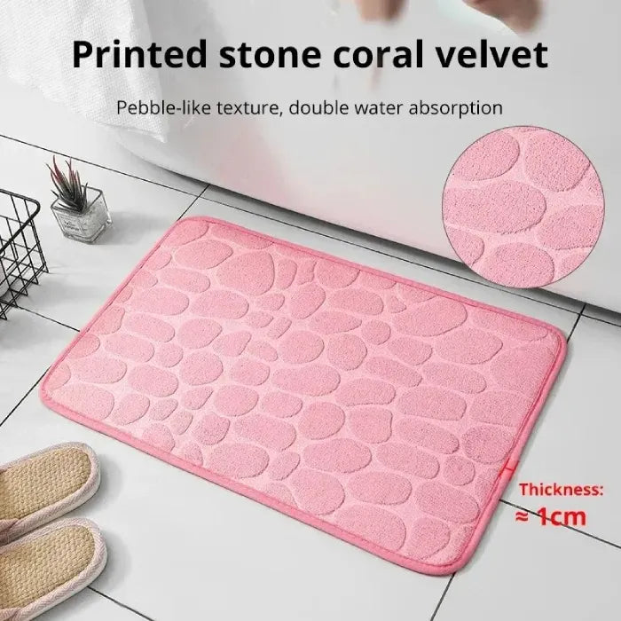 Pink coral velvet bath mat showcasing double water absorption and thickness.