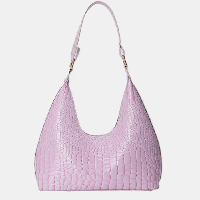 Pale pink crocodile-patterned shoulder bag with curved shape and single strap