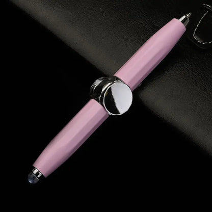 Pink fidget spinner pen featuring dual stylus ends on a dark leather backdrop.