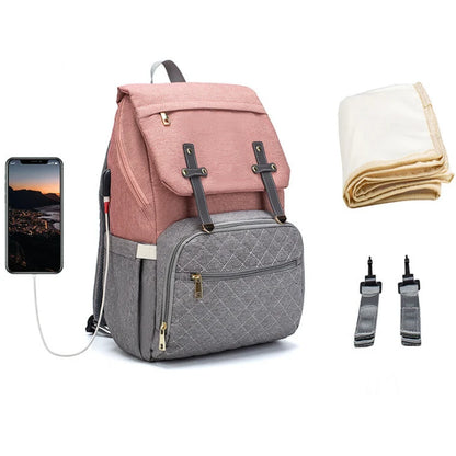 Modern diaper backpack with USB charging port, quilted grey pocket and pink design perfect for stylish parents on-the-go