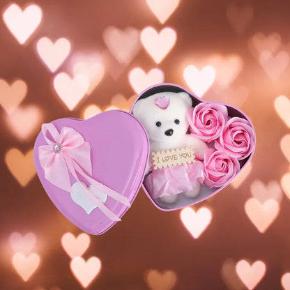 Pink heart gift box with teddy bear and roses against dreamy heart bokeh background