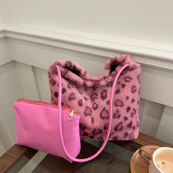 Pink leopard faux fur handbag paired with a matching pink pouch, great for stylish everyday use.