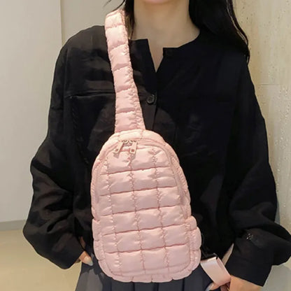 Pink puffer sling bag worn with black shirt, showcasing a casual chic style combination