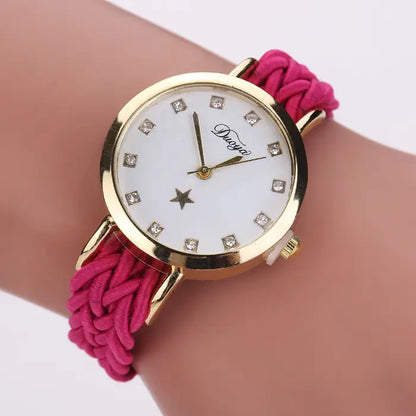 Women's watch with a gold case, white dial, and pink braided rope band.