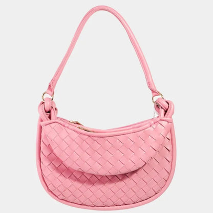 Front view of pink woven leather handbag with knotted handle and curved shape