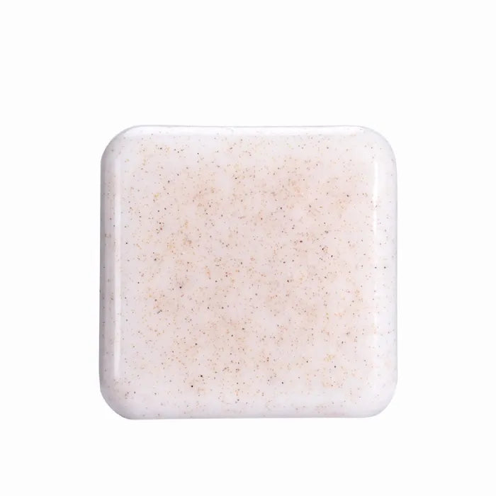 Plain white natural scrub soap bar with fine exfoliating particles.