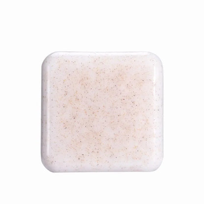 Plain white natural scrub soap bar with fine exfoliating particles.