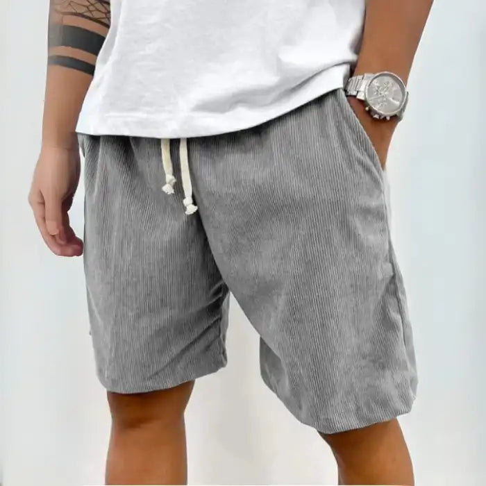  Plus Size Men's Corduroy Shorts in grey with adjustable drawstring waist and side pockets, paired with white shirt.