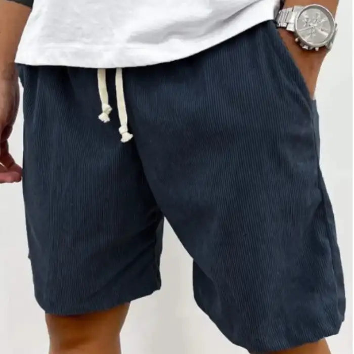 Plus Size Men's Corduroy Shorts in navy blue with adjustable drawstring and pockets, paired with white casual shirt.