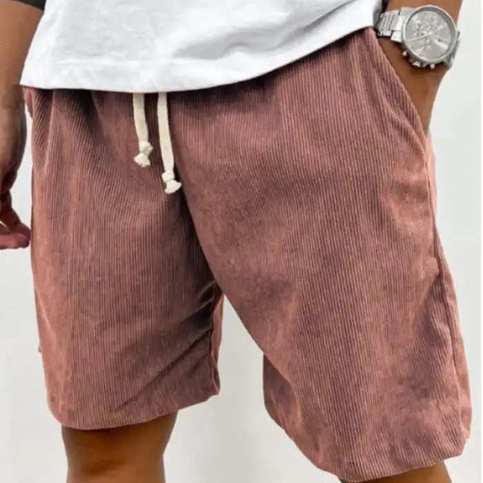 Plus Size Men's Corduroy Shorts in rust brown color, drawstring waist and side pockets, styled with white t-shirt.