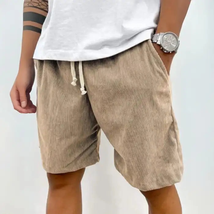  Plus Size Men's Corduroy Shorts in tan color with drawstring waist and side pockets worn with white t-shirt.