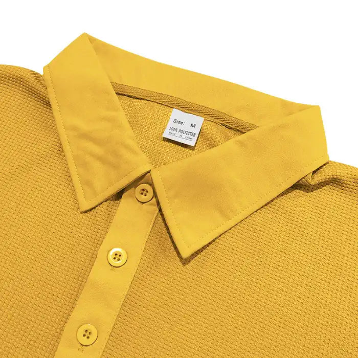 Close-up of plus size yellow polo shirt collar and buttons with waffle knit fabric texture.