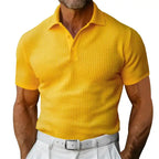 Plus size yellow polo shirt worn by a male model with white pants and textured knit fabric.