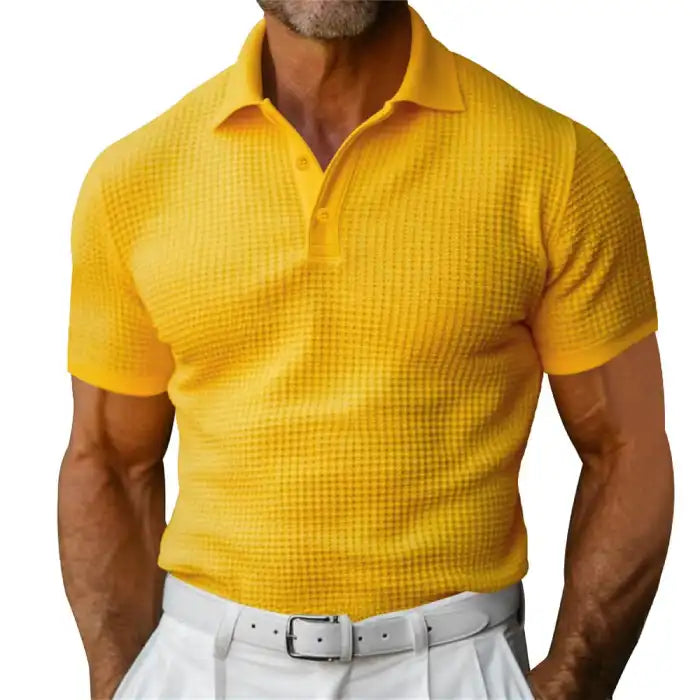 Plus size yellow polo shirt worn by a male model with white pants and textured knit fabric.