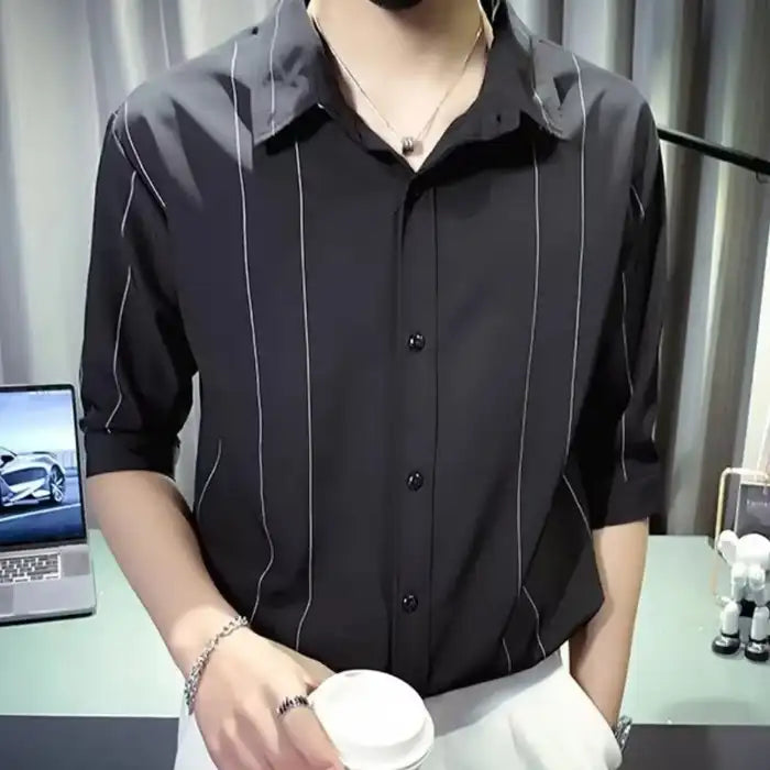 Plus size black striped button up casual shirt with short sleeves worn with white pants