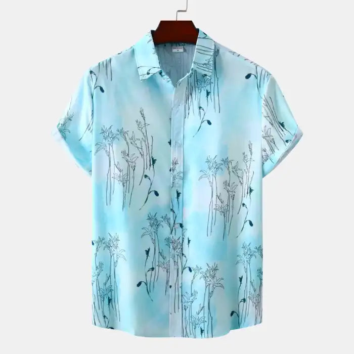 Plus size tropical shirt for men in light blue with floral patterns and short sleeves front view.