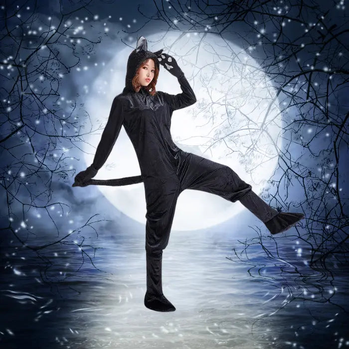 Plush black cat costume worn under moonlight with whimsical forest and water reflection background.