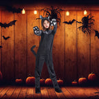 Plush black cat costume in pumpkin-decorated wooden room with bats and Halloween lights.