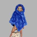 Plush Hooded Cape Coat in vibrant blue faux fur with oversized hood, premium winter outerwear bringing warmth comfort and bold style