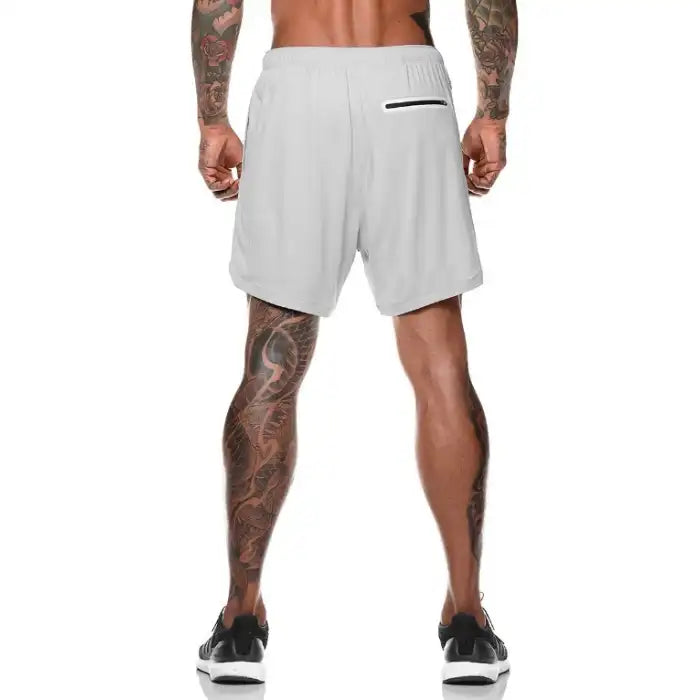  Back view of gray pocket compression shorts featuring a zippered back pocket for secure storage.