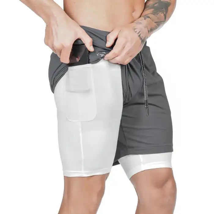 Pocket compression shorts in gray with white inner lining and phone pocket, ideal for gym training.