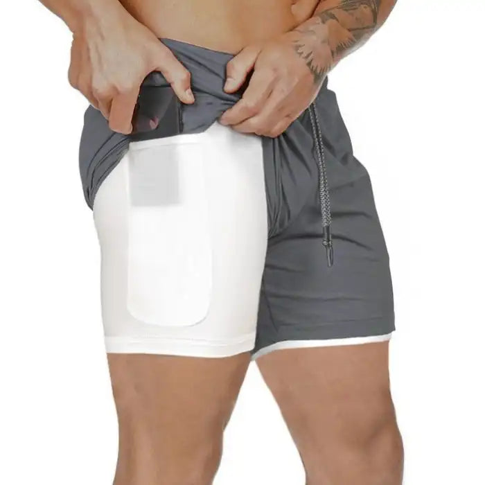 Gray compression shorts with white lining, inner thigh pocket designed to hold mobile phone.