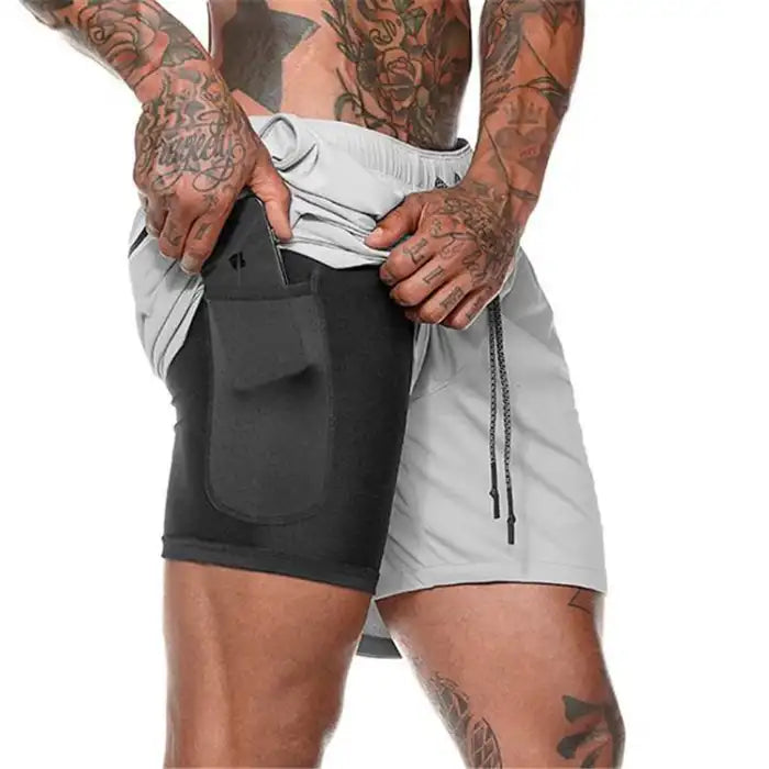 Light gray pocket compression shorts with contrasting black phone pocket for active lifestyle use.