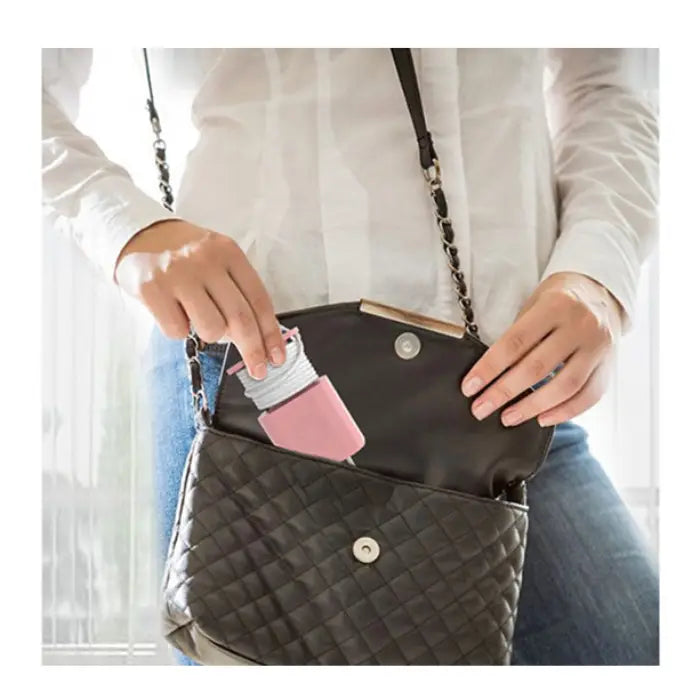 Portable pink charger organizer shown being stored in a handbag for convenient travel use.