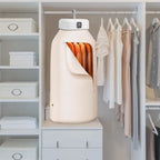 Portable cloth drier in modern closet drying several garments inside a zippered bag enclosure