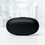 Portable red light therapy device case on white surface shows compact black design for nasal treatment at home.