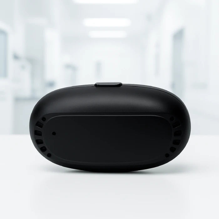 Portable red light therapy device case on white surface shows compact black design for nasal treatment at home.