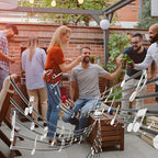 Portable speaker boosting sound at an outdoor party with friends enjoying drinks and music