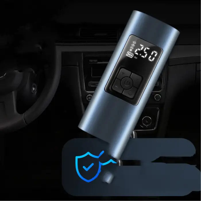 Portable tire inflator with digital display in car interior, showing air pressure reading of 2.50 bar.