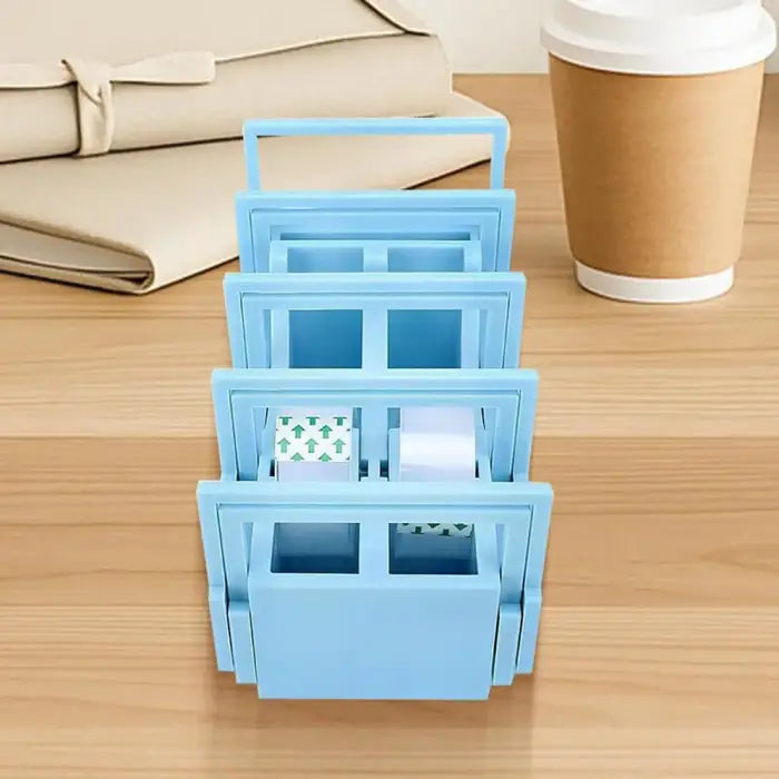 Precut tape dispenser placed on a tidy wooden desk with coffee cup and packages in background.