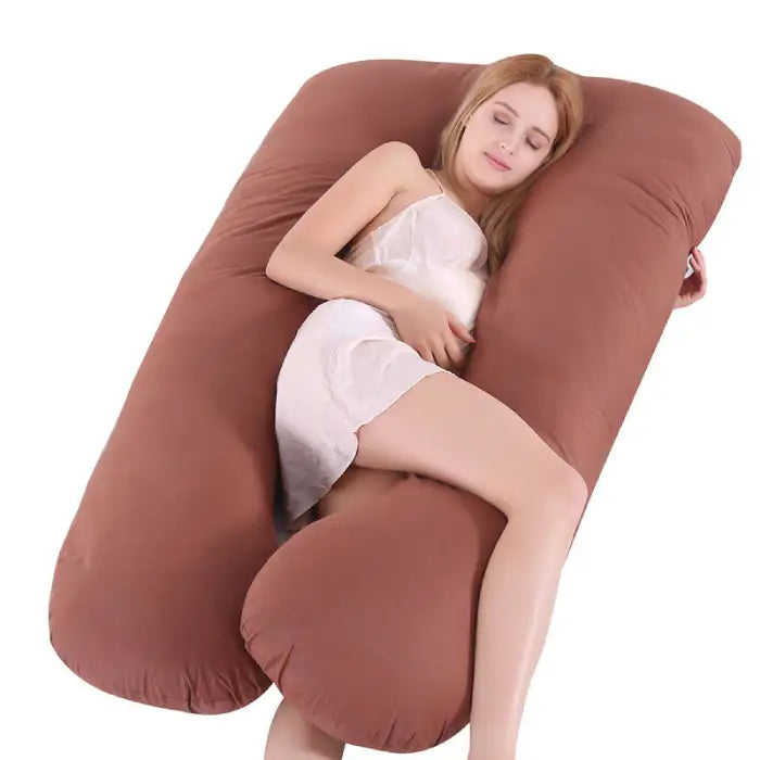 Brown pregnancy pillow designed to contour and support the body for restful sleep.