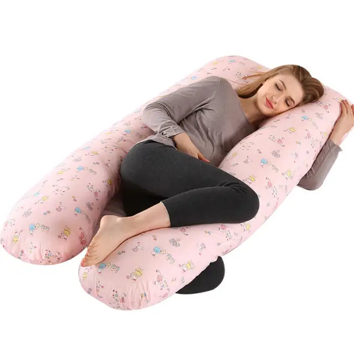 Cute pink pregnancy pillow with cartoon pattern designed for cozy side sleeping support.