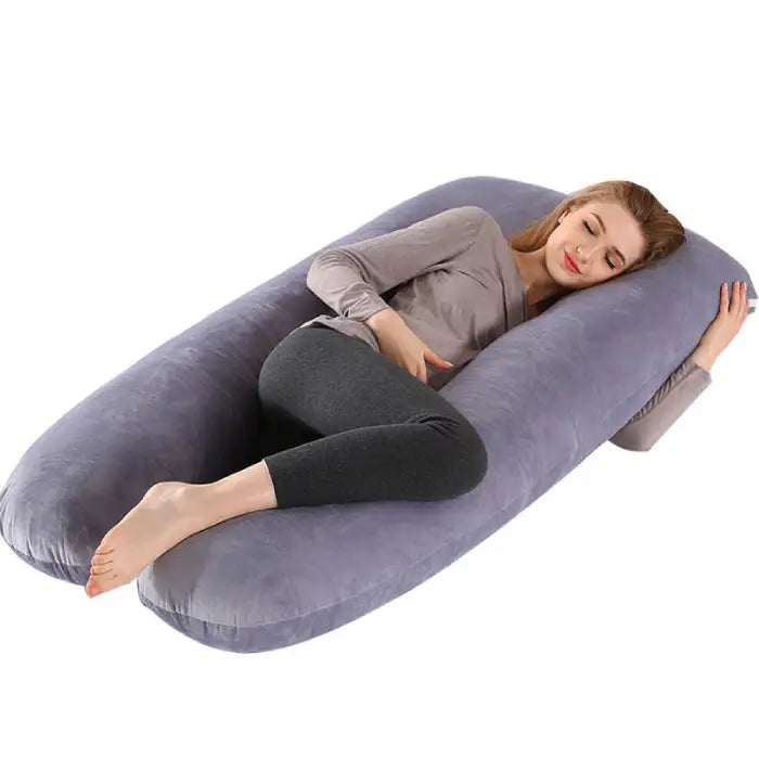Full-body pregnancy pillow in gray velvet fabric supporting side sleep for expectant mothers.