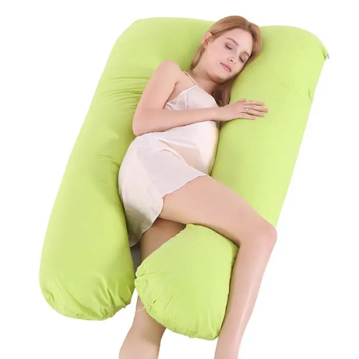 Soft green pregnancy pillow enhancing sleep comfort and supporting full-body alignment.