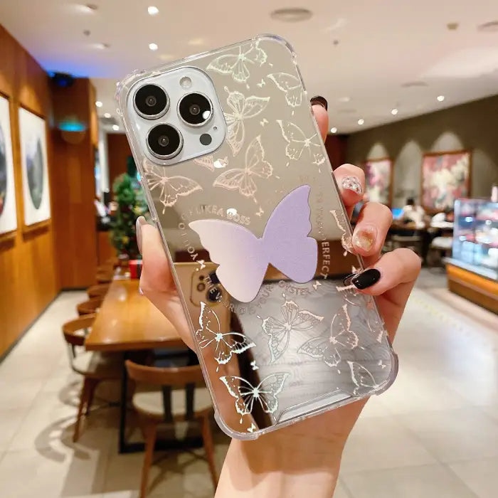 Protective iPhone 15 case featuring transparent background with elegant silver butterfly patterns and purple butterfly accent in center
