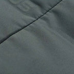 Puffer Blazer Jacket close-up of smooth stitched padding in charcoal grey for insulated structure.