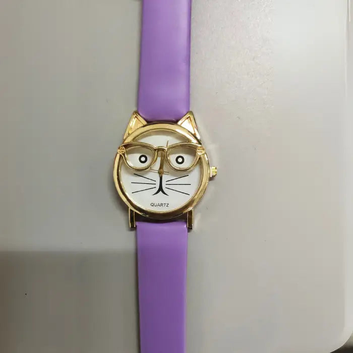 Unique purple strap wristwatch with a gold cat-ear design and a white dial featuring a whimsical cat face pattern.