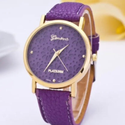 Purple women's watch with a gold floral-patterned dial and purple leather strap.