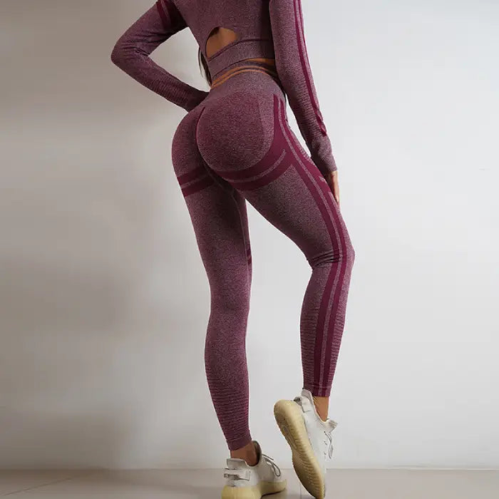 Rear view of purple high-waisted seamless yoga leggings with contour detailing