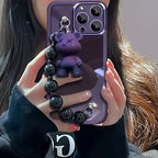 Purple Kuwaii Phone Case with dangling purple bear charm and black beaded bracelet strap.