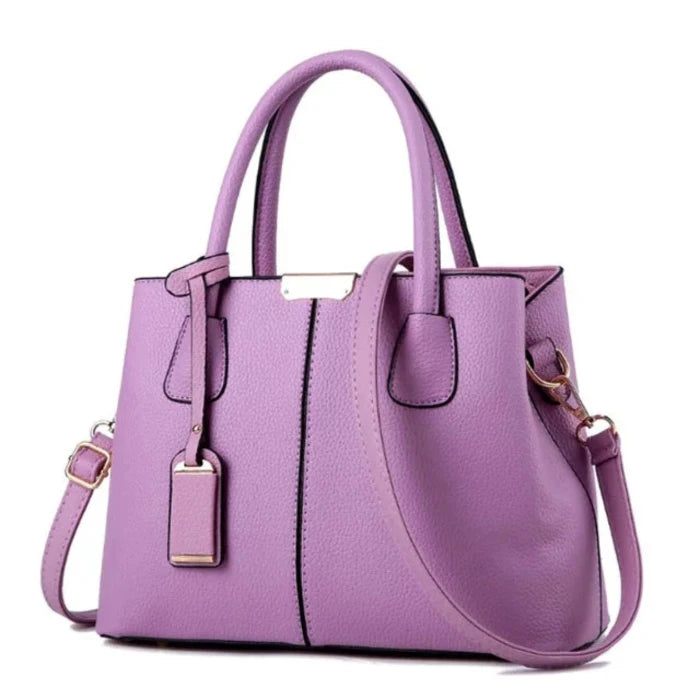 Fashionable purple leather tote bag with gold accents and detachable strap for stylish women.