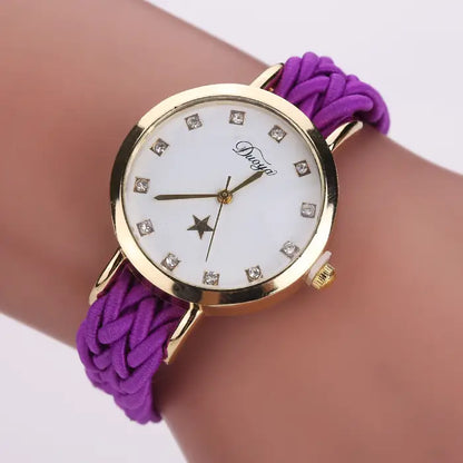 Women's watch with a gold case, white dial, and purple braided rope band.