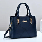  Quilted faux leather satchel handbag in navy blue with diamond pattern, dual handles, gold hardware, front view.